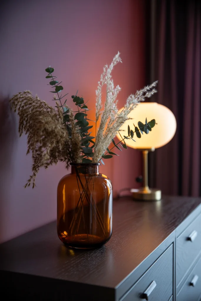 dried pampas grass and eucalyptus in amber glass vase