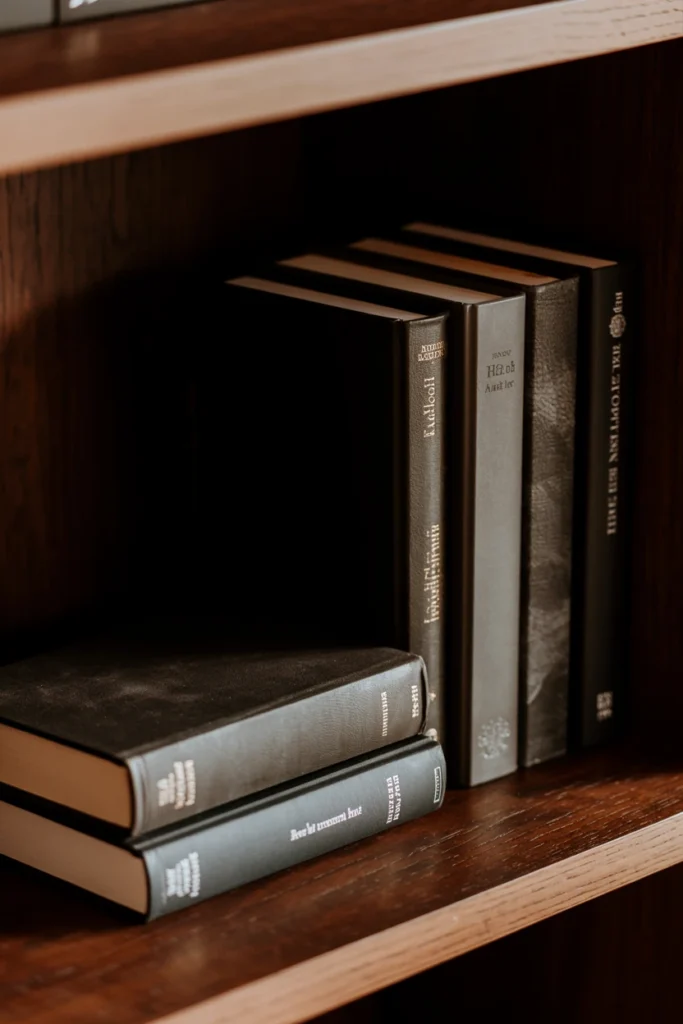 Stack of dark leather-bound books used as a grimoire display