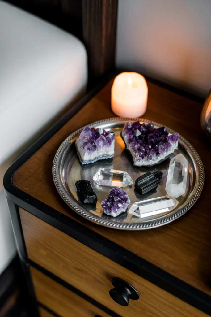 tarnished silver tray holding amethyst and quartz crystals
