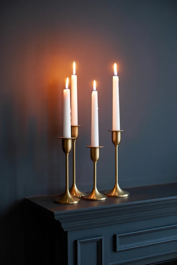 Varying height taper candles on dark wood mantel