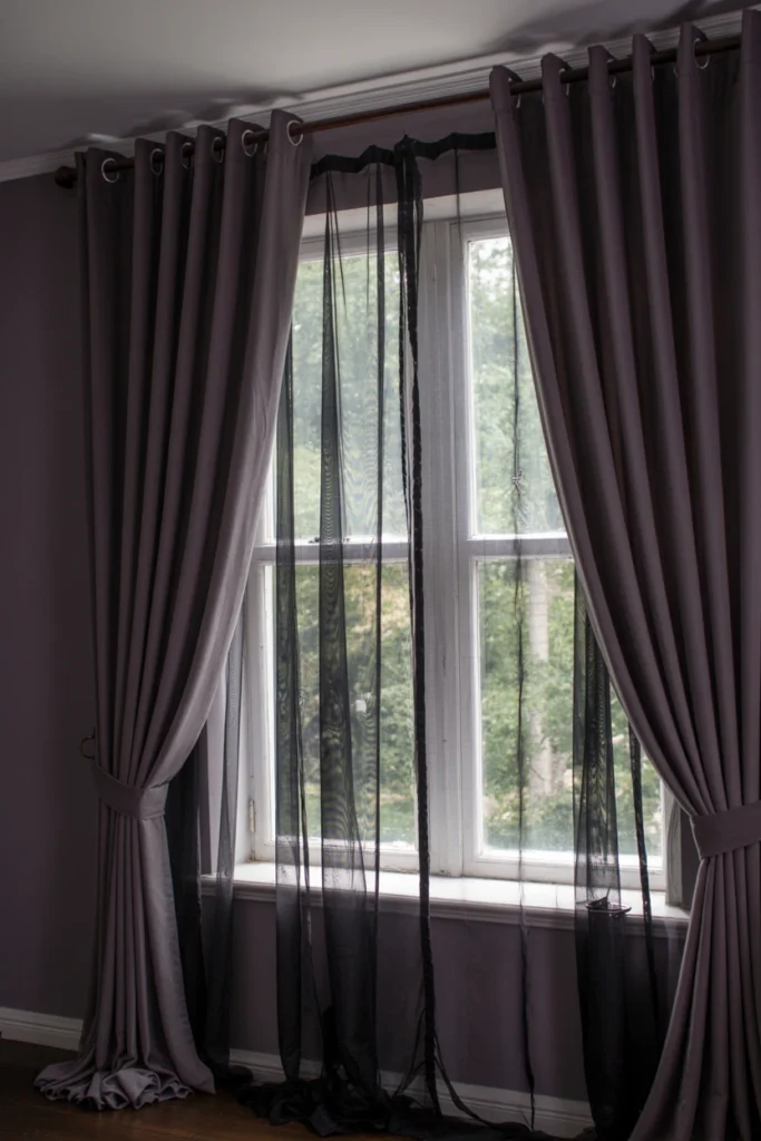 sheer black curtain layered under dark velvet drapery