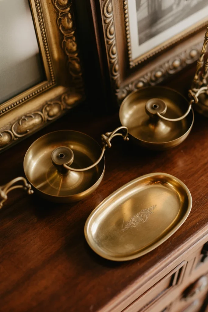 Antique brass candle sconces and picture frames grouped together