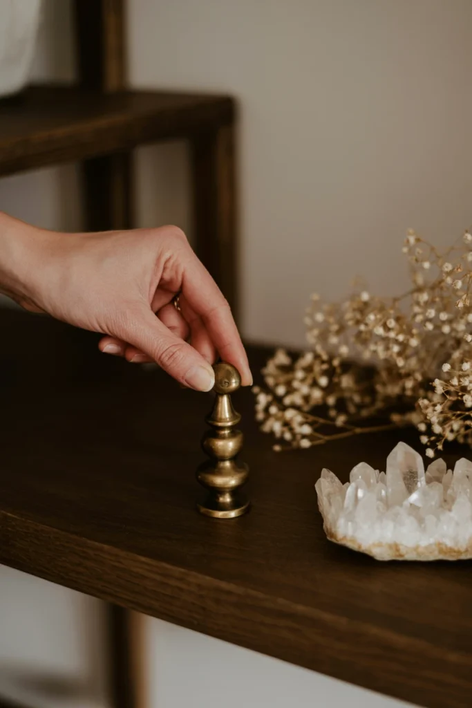 Single new antique object being placed on styled shelf