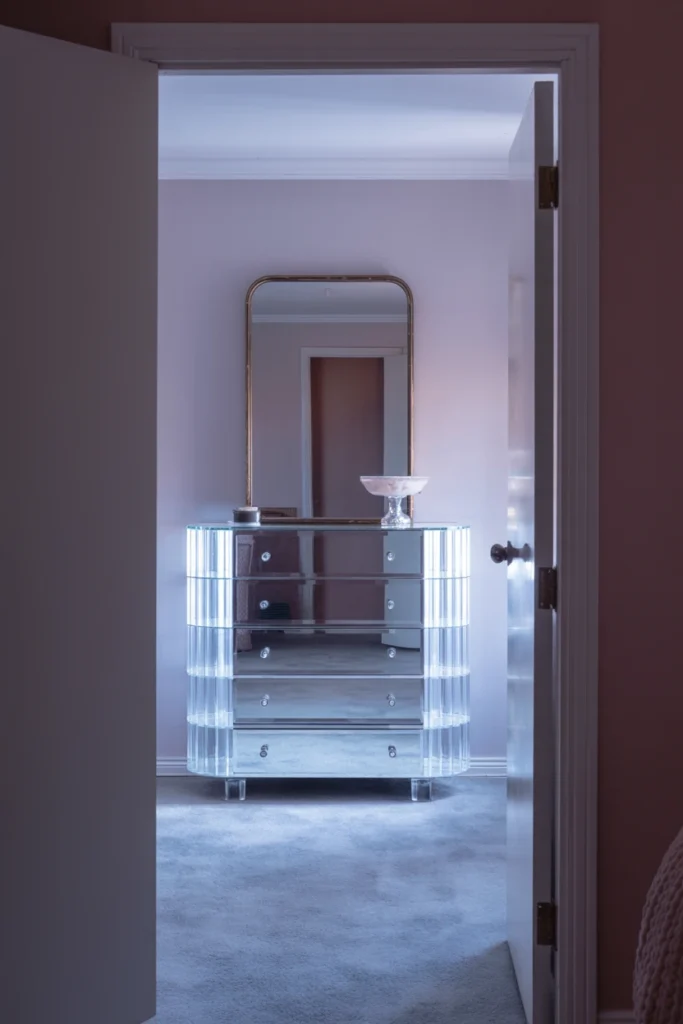 Lucite waterfall dresser positioned as the hero piece in an 80s bedroom