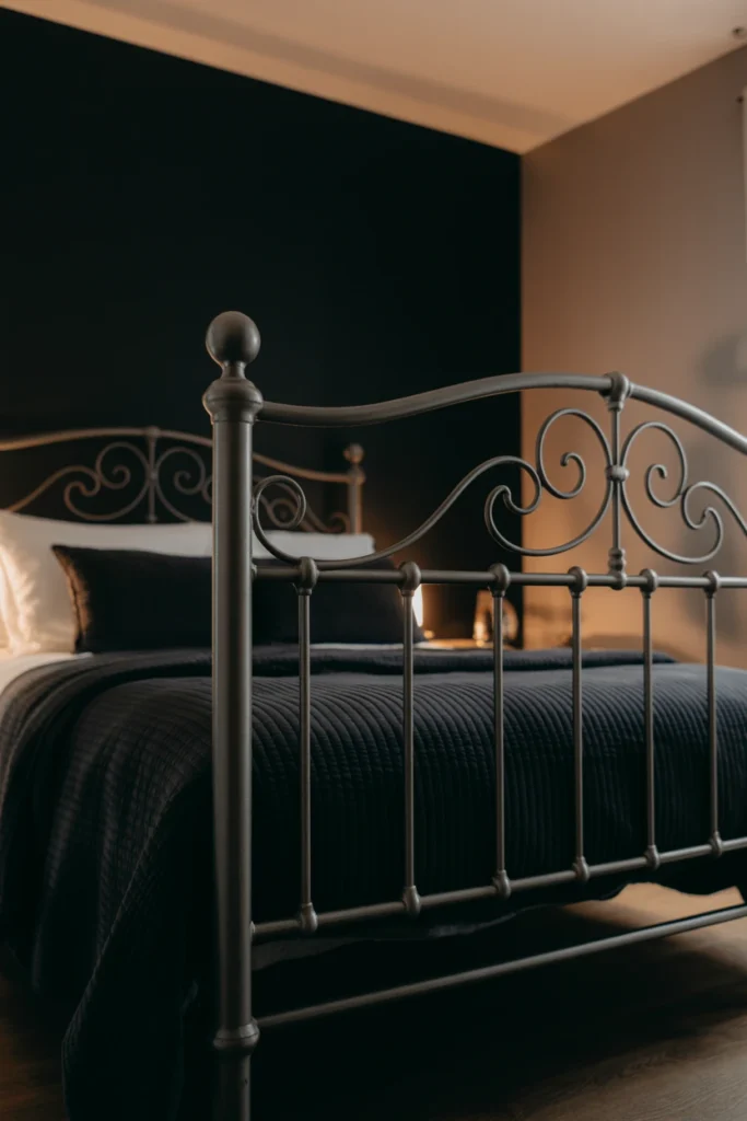 Dark wrought iron scrollwork bed frame in moody bedroom