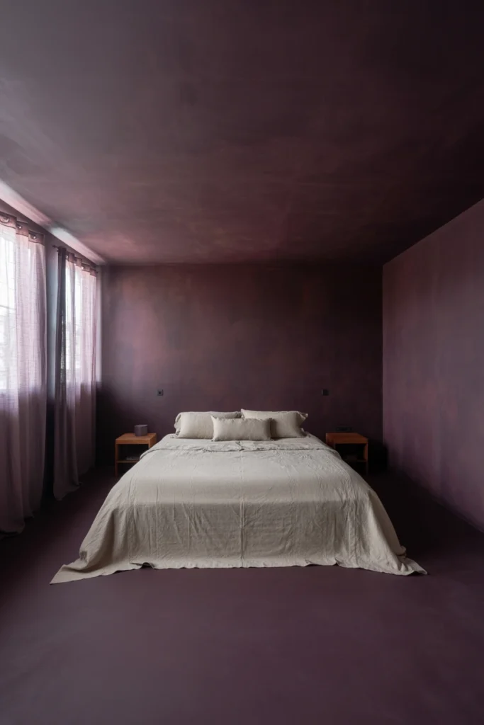 Paint walls in a deep charcoal, aubergine, or espresso base