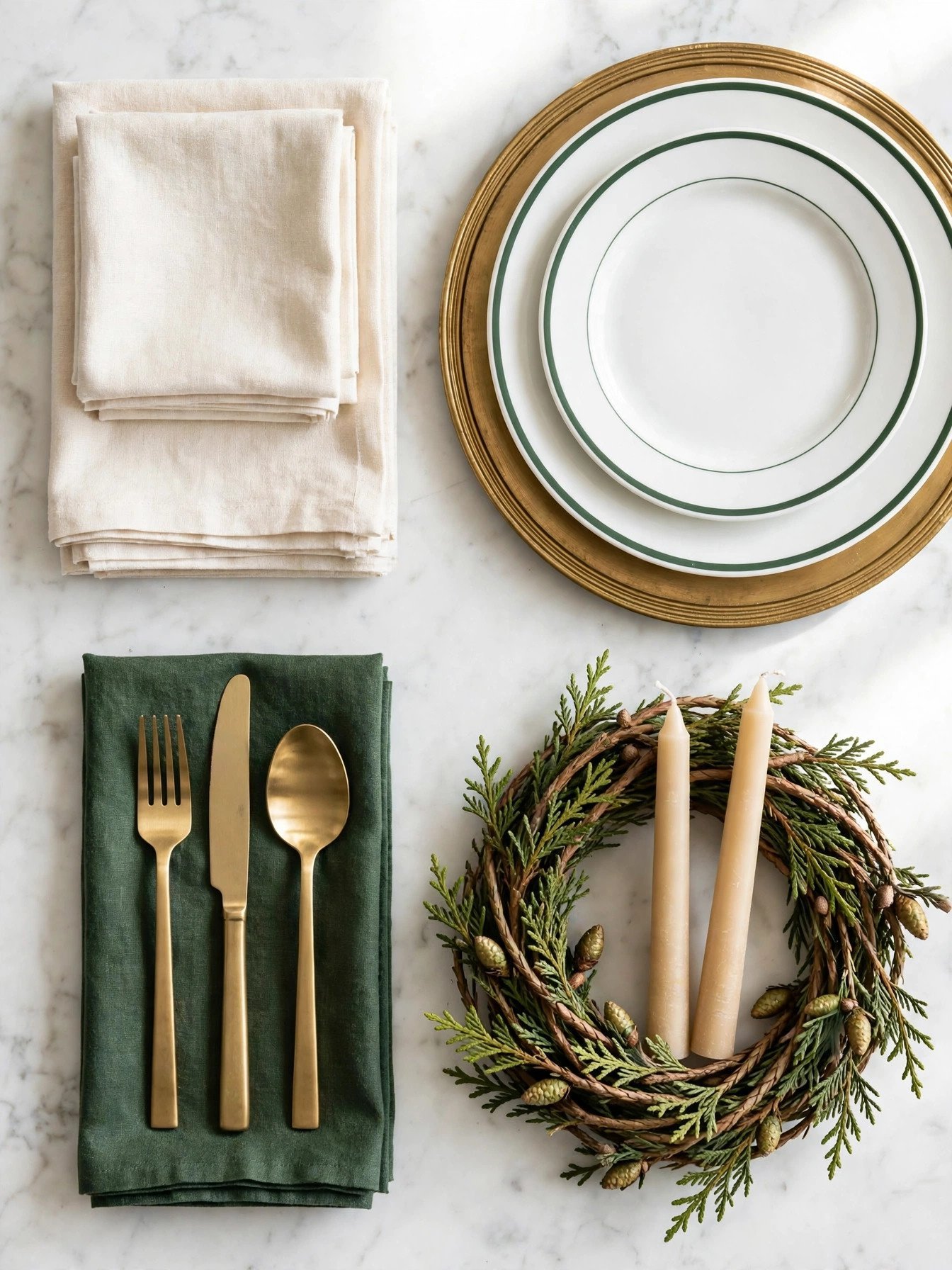 Flat lay of Christmas table components sorted into linens, dinnerware, flatware, and decor groups